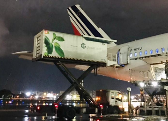 Global Catering truck loading an aircraft at night